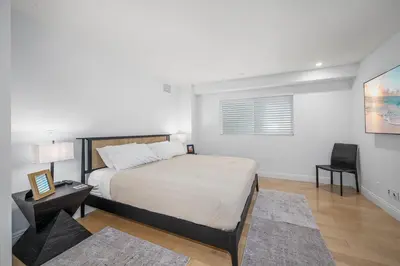 a bedroom with a bed and a desk and a chair at Ocean Views in Long Beach in Long Beach