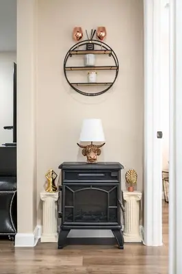 a living room with a fireplace and a lamp at Heartwarming Family Stay 10 Min Walk to Pomona Valley Hospital in Pomona