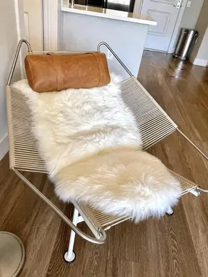 a bench with a white fur rug on it at Designer 2 Bedroom with 3 Beds- Pool View, Gym, Parking in Los Angeles