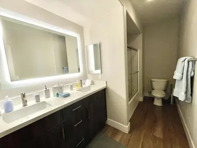 a bathroom with a sink and a toilet and a mirror at Designer 2 Bedroom with 3 Beds- Pool View, Gym, Parking in Los Angeles