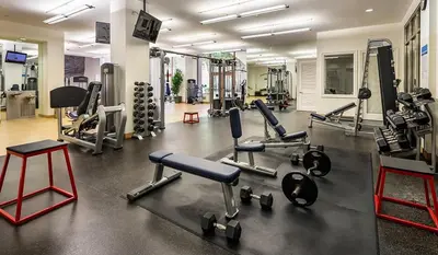 a gym with several treadmills and machines in it at Designer 2 Bedroom with 3 Beds- Pool View, Gym, Parking in Los Angeles
