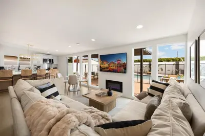 a living room with a couch and a fireplace at Stylish 5 Bedroom Villa with Pool near Disney - Luxury Family Retreat in Anaheim