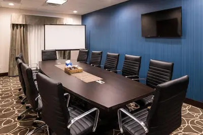 a conference room with a large table and chairs at Holiday Inn Express & Suites Bakersfield Airport by IHG in Bakersfield
