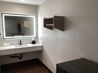 a bathroom with a sink and a mirror at Mayfair Inn Onratio Airport & Convention Center in Ontario