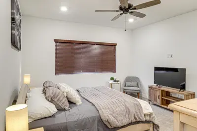 a bedroom with a bed and a flat screen tv at 9 Mi to Dtwn Bakersfield Pet-Friendly Home in Bakersfield