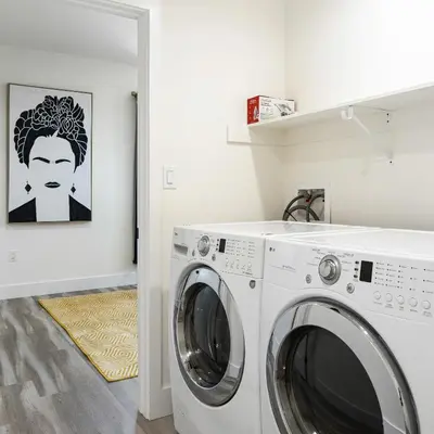 a laundry room with a washer and dryer at Sophisticated Getaway Hollywood & Dtla in Los Angeles