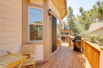 a porch with a bench and a grill on a house at Walkable Big Bear Lake Home with Private Hot Tub! in Big Bear Lake