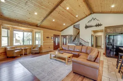 a living room with a couch and a tv at Walkable Big Bear Lake Home with Private Hot Tub! in Big Bear Lake