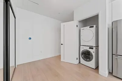 a white laundry room with a washer and dryer at Stylish LA studio Prime Location in Los Angeles