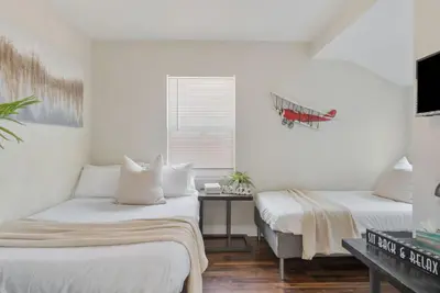 a room with two beds and a table in it at Travel Haven - Great Location - Quiet Area in Long Beach