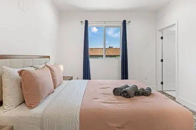 a bedroom with a bed with two pairs of binoculars on it at Contemporary Retreat Hollywood & DTLA in Los Angeles