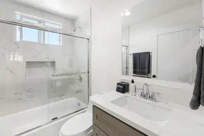 a white bathroom with a sink and a shower at Contemporary Retreat Hollywood & DTLA in Los Angeles