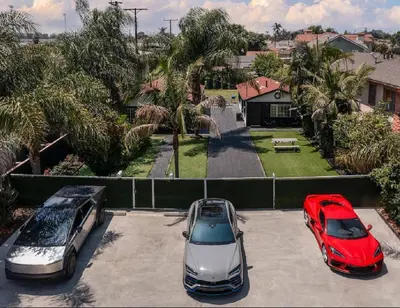 two cars parked in a parking lot in front of a house at LUXURY VILLA Estate Oasis in Downey