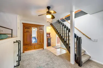 a staircase in a home with a ceiling fan at Between Big Bear and Lake Arrowhead - Cabin with View! in Running Springs