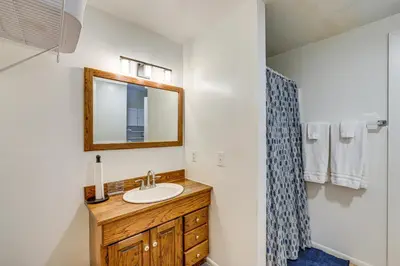 a bathroom with a sink and a mirror at Between Big Bear and Lake Arrowhead - Cabin with View! in Running Springs