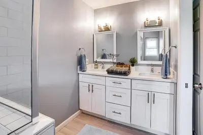 a bathroom with two sinks and two mirrors at Golf, Swim, Relax Family Retreat in Corona! in Corona