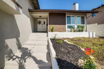 a house with a pathway leading to the front door at Golf, Swim, Relax Family Retreat in Corona! in Corona