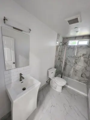 a white bathroom with a sink and a toilet at San Marino guest house in Los Angeles