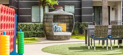 a bird cage with chairs and a table in front of a building at Noho Haven 2 bed Apt with FREE Parking in North Hollywood