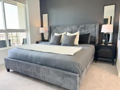 a bedroom with a large bed with a large window at Modern 1BR Apartment with Pool, Hot Tub and Gym Access 10mins to Universal Studios in Los Angeles