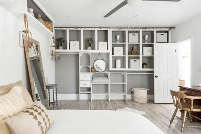 a room with white shelves and a table and a bed at Silver Triangle Oasis with Verdant Backyard in Los Angeles