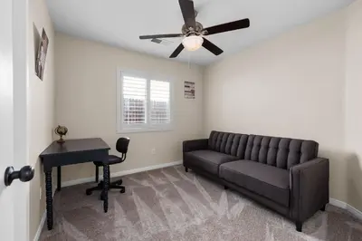 a living room with a couch and a ceiling fan at Relaxing 4BR 2BA Sleeps 8 Family Friendly in Bakersfield