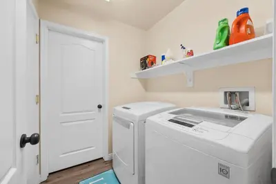 a white laundry room with a washer and dryer at Relaxing 4BR 2BA Sleeps 8 Family Friendly in Bakersfield