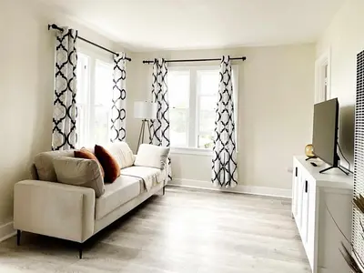 a living room with a couch and a tv at Montecito Heights Hideaway in Los Angeles
