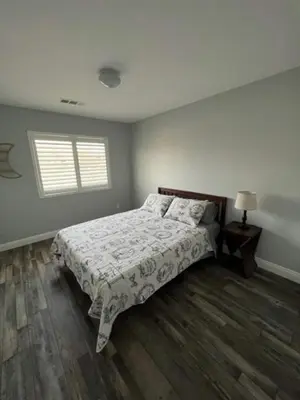 a bedroom with a bed and a window at Cadbury 4BR Outdoor Kitchen Sleeps 8 Peaceful in Bakersfield