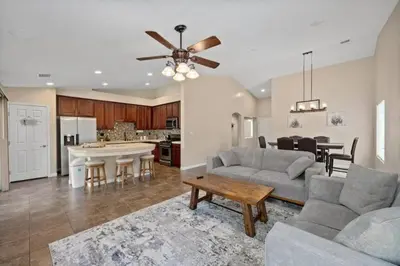 a living room with a couch and a table at 4bdrm 2bath Modern Getaway KING Bed Sleeps 8 in Bakersfield