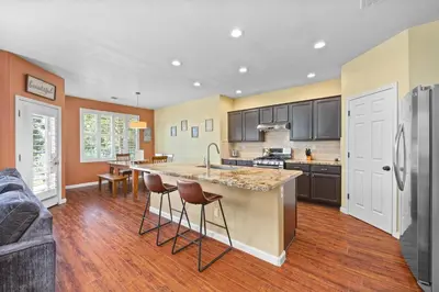 a kitchen with a large island with bar stools at Luxury Gated Retreat Golf Course Views Sleeps 8 in Bakersfield