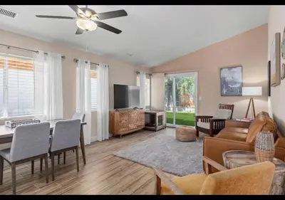 a living room with a couch and a dining room at Modern Southwest Escape 2 Master Bedrooms in Bakersfield