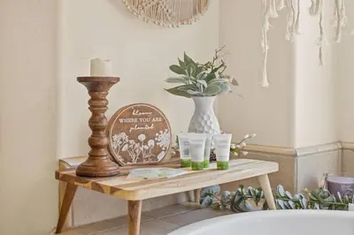 a table with a candle and a vase on it at Spacious 4BR 3BA Home KING Suite Pool Sleeps 8 in Bakersfield
