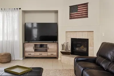 a living room with a television and a fireplace at Stylish Silver Falls 4BR KING Master Game Room in Bakersfield