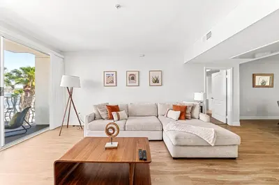 a living room with a couch and a table at Acacia Waterfront Marina Views Pool Gym Jacuzzi And Sauna in Los Angeles