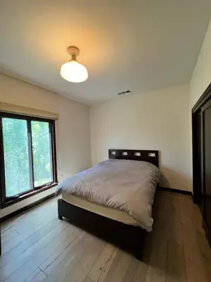 a bedroom with a bed and a large window at Beachwood in Los Angeles