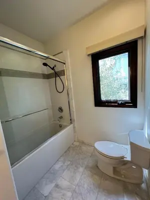 a bathroom with a toilet and a tub and a sink at Beachwood in Los Angeles