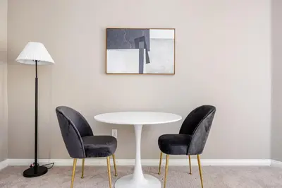 a table with two chairs and a table with a lamp at Blueground Pasadena pool AC nr City Hall LAX-1315 in Los Angeles