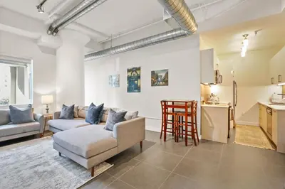 a living room with a couch and a table at Stunning DTLA Gem 2 bed with pool, gym and parking in Los Angeles