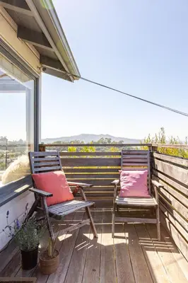 two chairs sitting on a deck with a view at Serene & beautiful bohemian hilltop retreat in Glendale