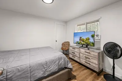 a bedroom with a bed and a flat screen tv at Cozy Knight Cabin - AC! Walk to Lake and Village in Big Bear Lake