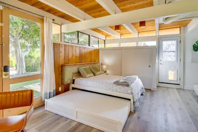a bedroom with a bed and a large window at Stroll to Beach and Pepperdine Airy Malibu Studio in Malibu