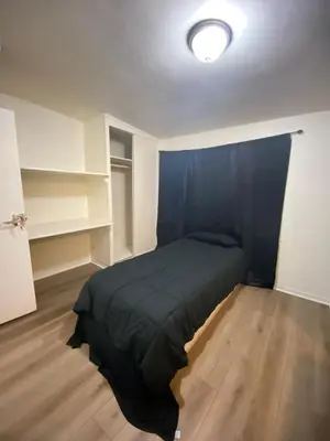a bedroom with a bed in a room with shelves at Van Nuys Vibe in Van Nuys County Court Heliport