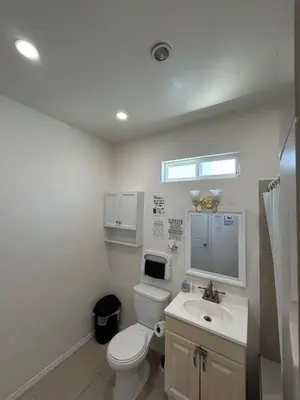 a bathroom with a toilet and a sink at Van Nuys Vibe in Van Nuys County Court Heliport