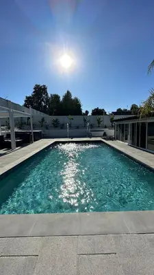 a swimming pool with the sun in the background at Wellness Villa Resort in Abbeyville