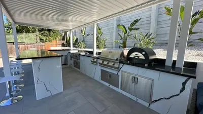 an outdoor kitchen with a counter and a grill at Wellness Villa Resort in Abbeyville