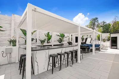 a patio with a bar with stools at Wellness Villa Resort in Abbeyville