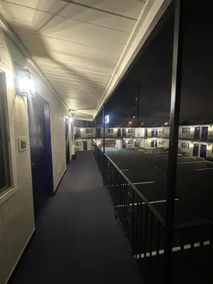 a hallway of an empty parking lot at night at Del Aire Inn LAX in Inglewood