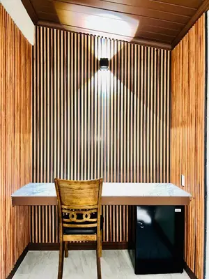 a wooden wall with a table and a wooden chair at Del Aire Inn LAX in Inglewood