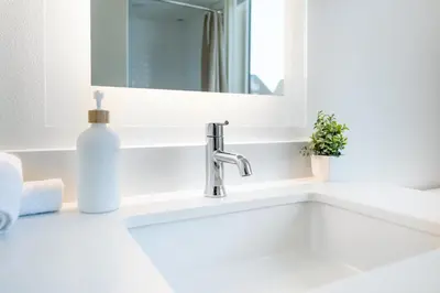 a white bathroom sink with a soap bottle on it at Luxury 2 Bedroom 2 Bathroom Residence With Fitness and Outdoor Pool in Los Angeles